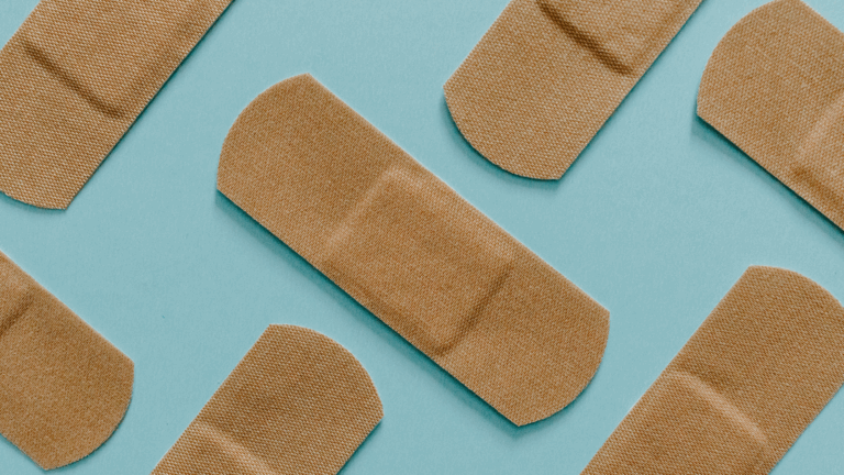 Bandaids spread out on a light blue background