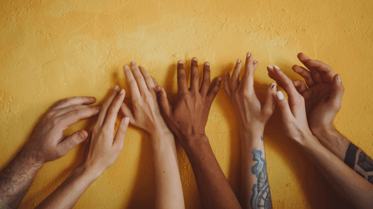 A group of diverse hands up in the air